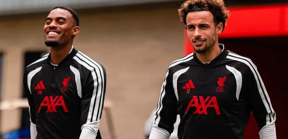 Two Liverpool players walking in training gear