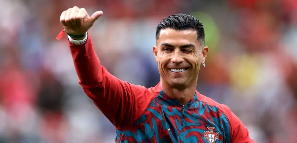 Player waving during warm-up in Portugal kit