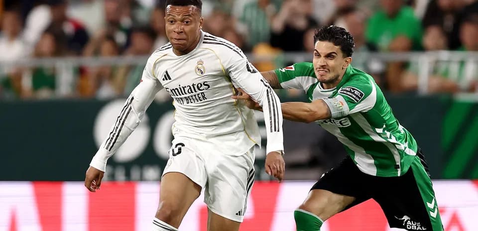 Player from Real Madrid evading a tackle during match