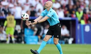 Referee preparing to throw the ball during match