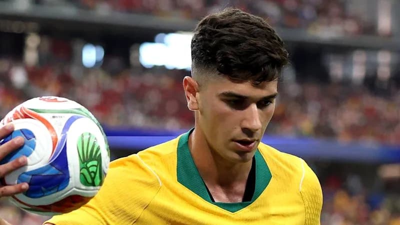 Player in yellow jersey holding a soccer ball