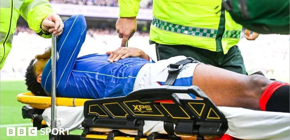 Player being assisted on stretcher by medical staff