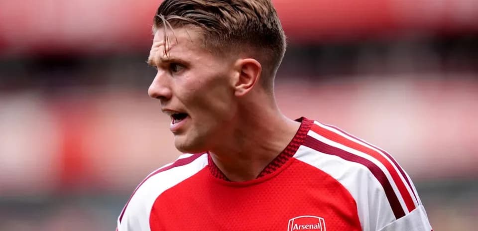 Player wearing Arsenal jersey during match action
