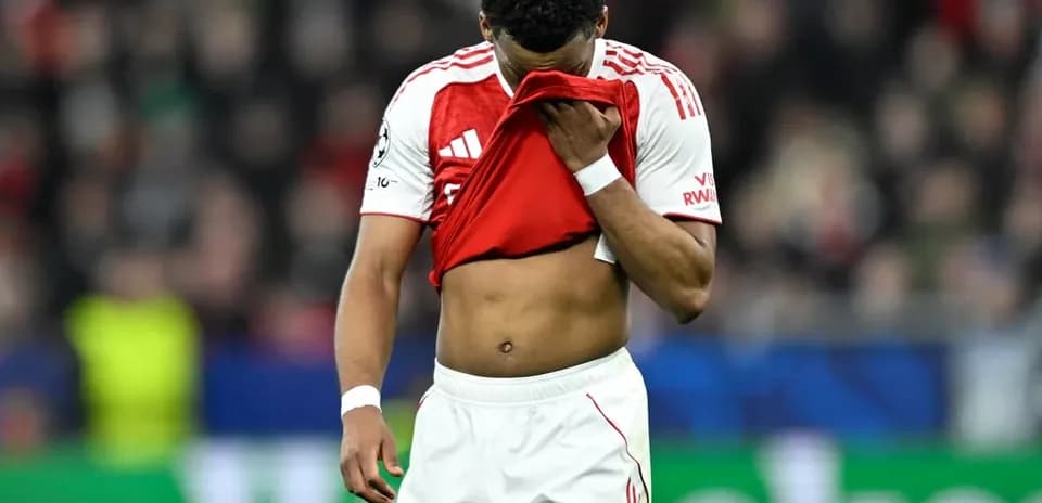 Player looking down, holding jersey after match