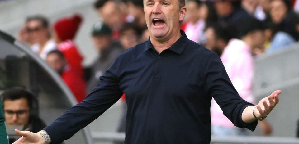 Coach gesturing passionately during a match