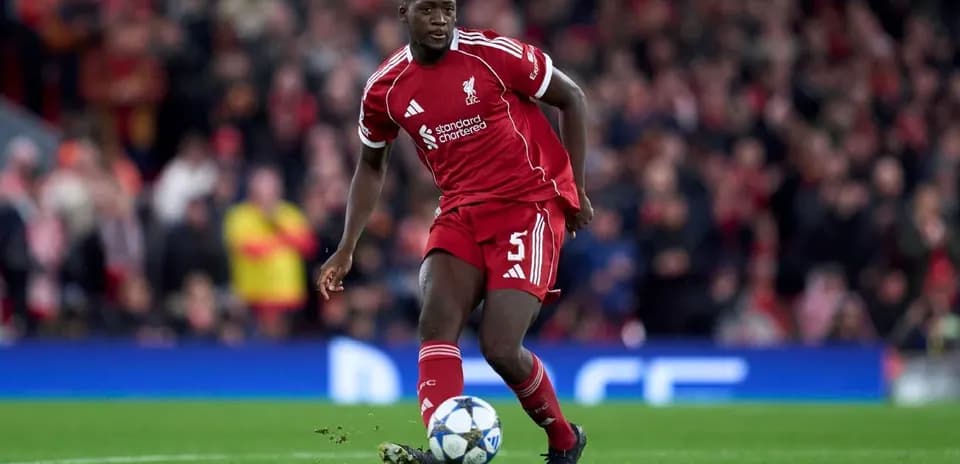 Liverpool player dribbling the ball on field