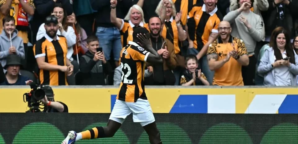 Player celebrating a goal with cheering fans
