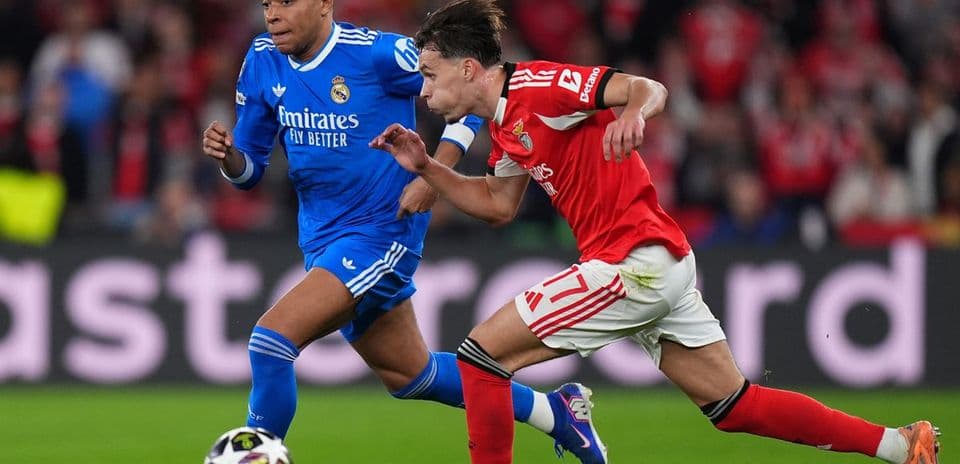Real Madrid celebrates after a Benfica 0–1 Real Madrid: Vinícius Júnior's Decisive Goal in Champions League Clashgoal against Benfica.