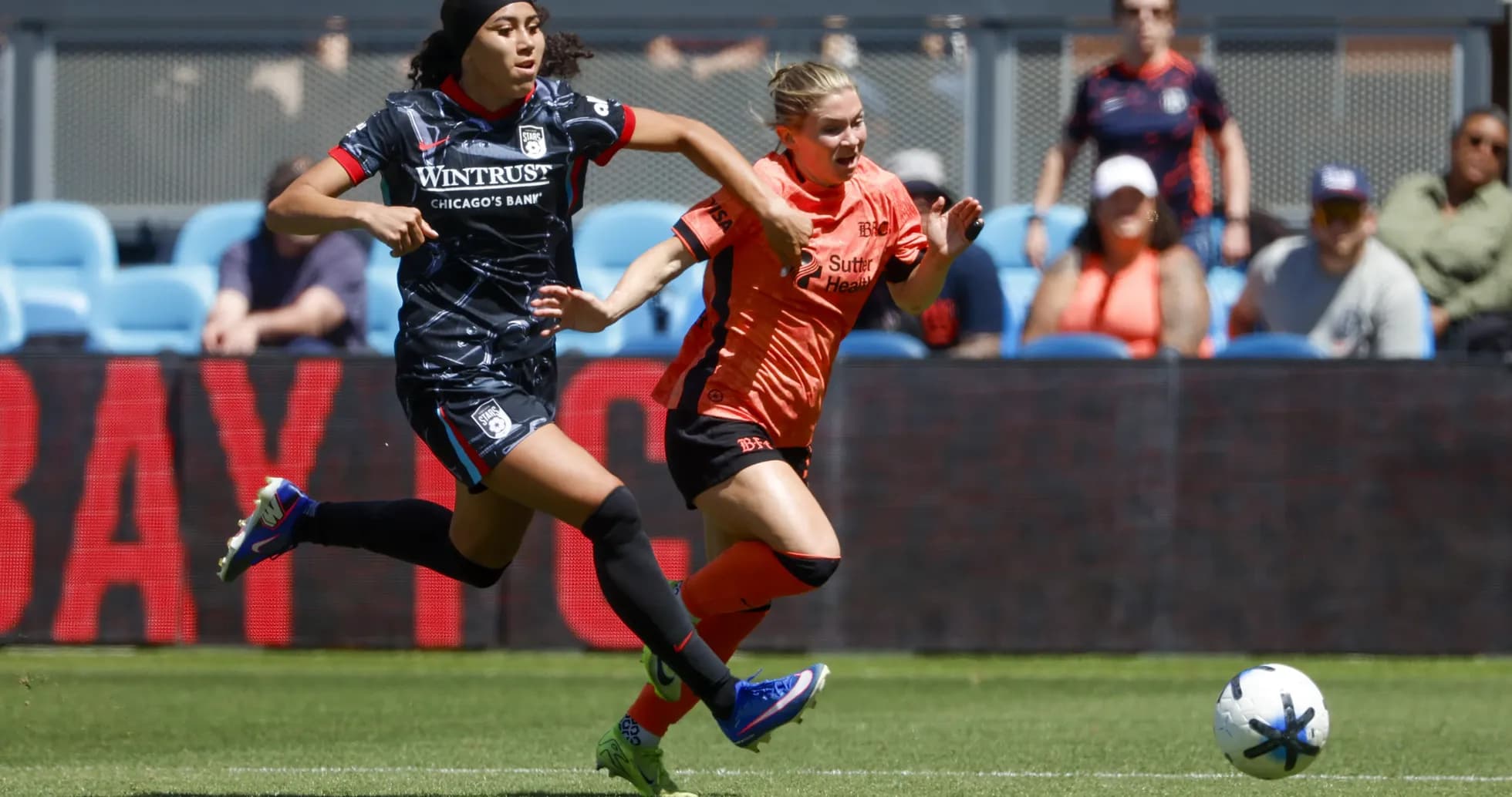 Players competing for the ball in NWSL match