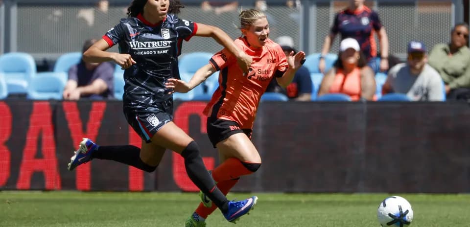 Players competing for the ball in NWSL match