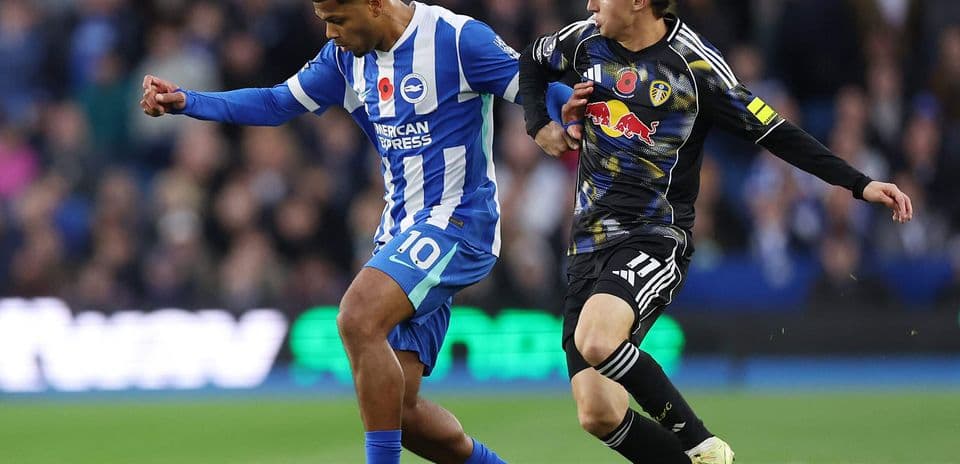 Brighton player dribbling against Leeds defender