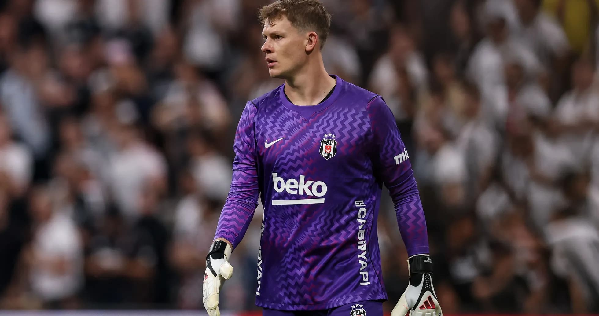 Goalkeeper in purple kit during match action
