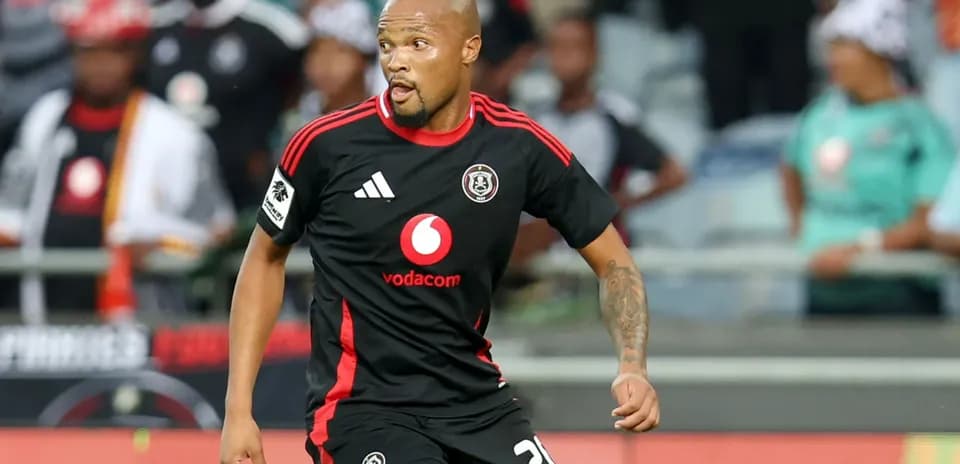Player in black jersey running on the pitch