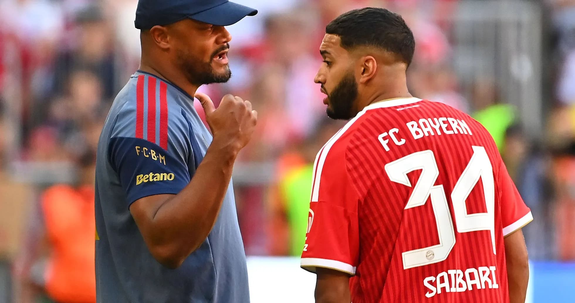 Coach discussing strategy with player on field