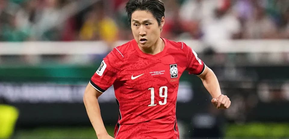Player in red jersey running during soccer match