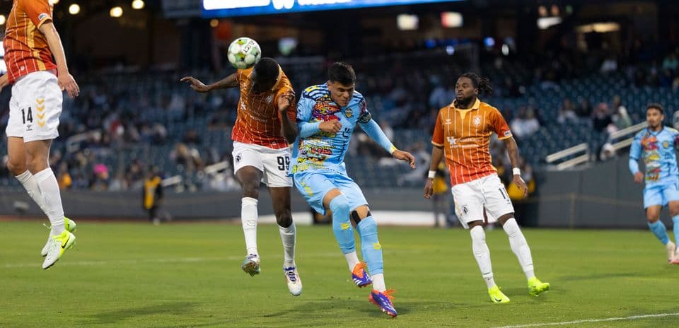 Players competing for the ball during match