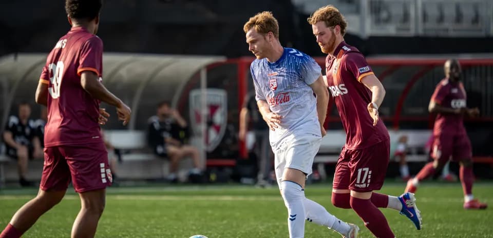Players competing for the ball in USL match