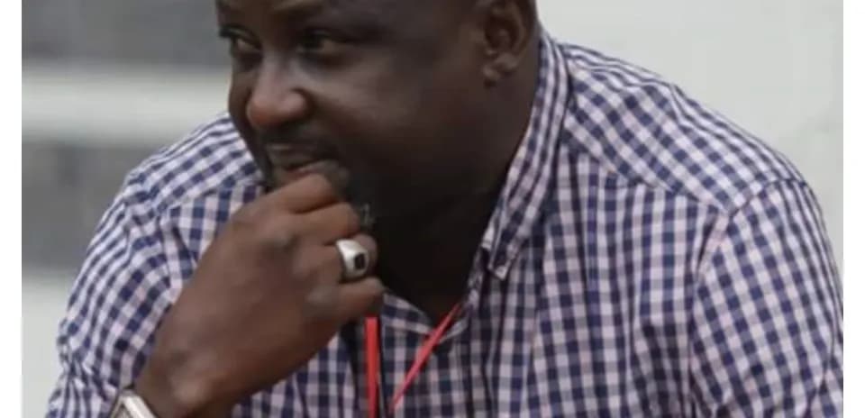 Man observing with hand on chin at event