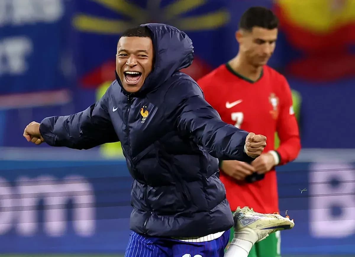 Kylian Mbappé celebrating in France jacket on field