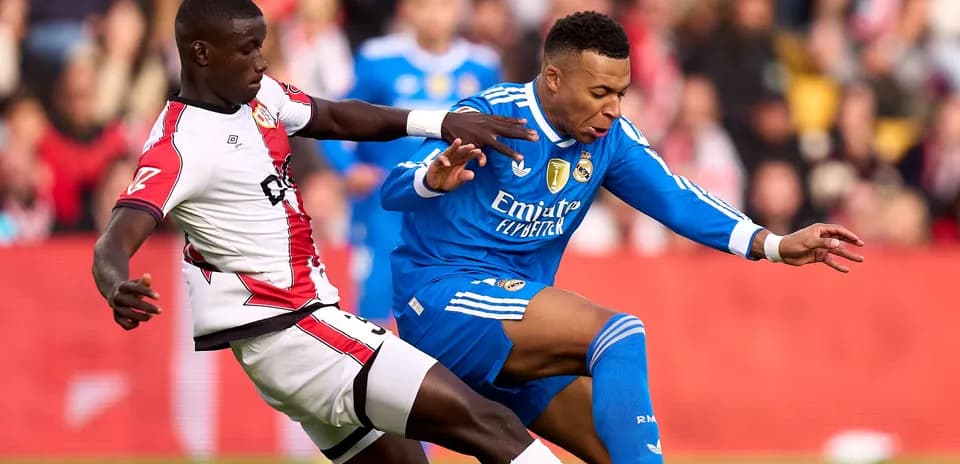 Player from Southampton tackling Real Madrid player