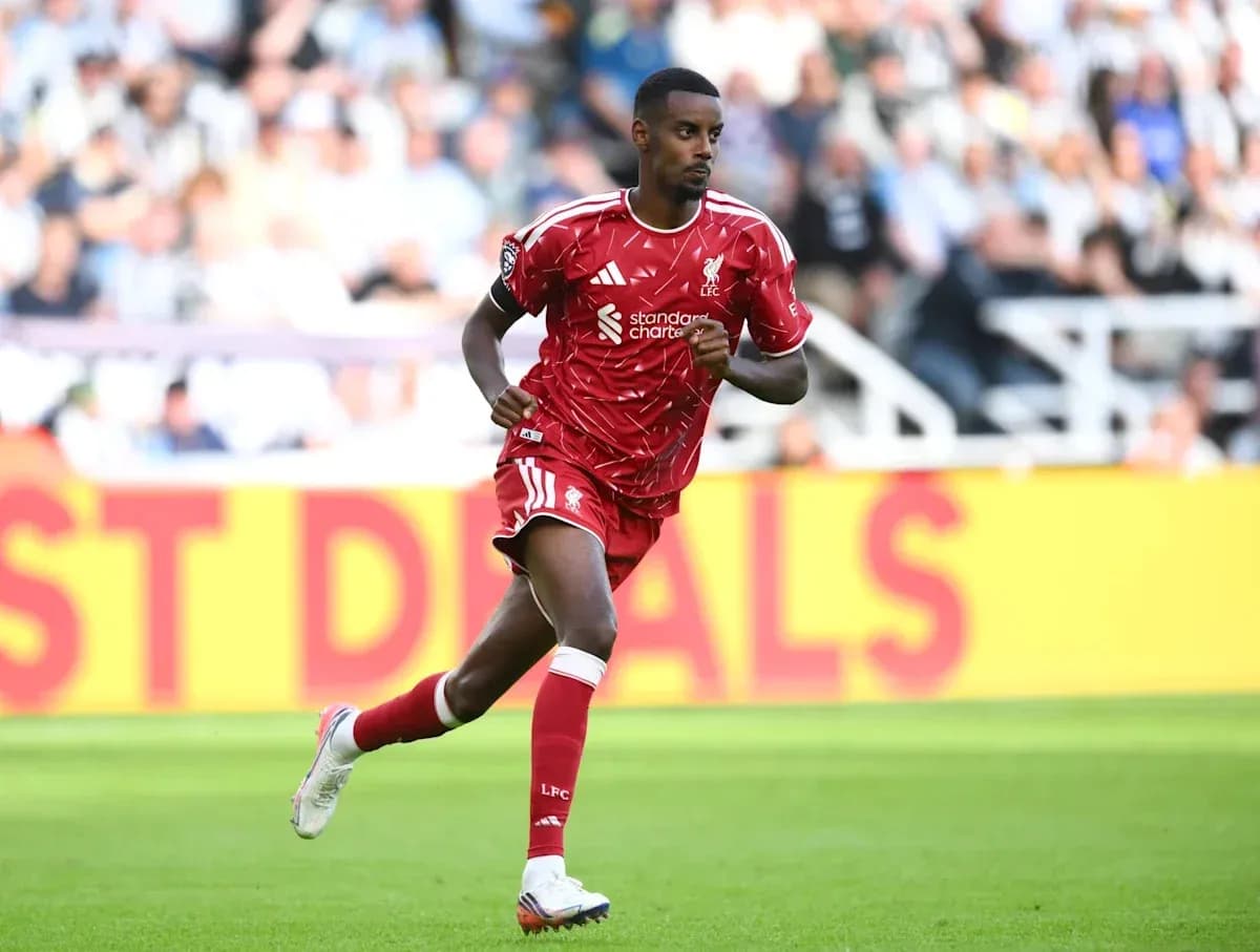 Player in red Liverpool kit running on pitch