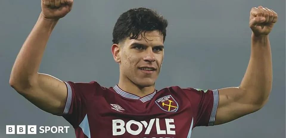 Player celebrating with raised fists in West Ham kit