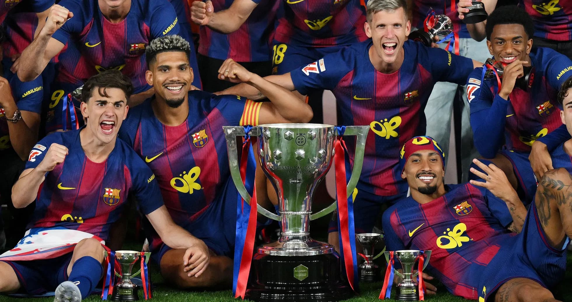 Barcelona players celebrating with trophies after victory