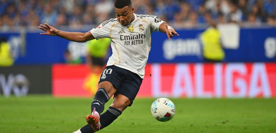 Real Madrid player kicking the ball during match