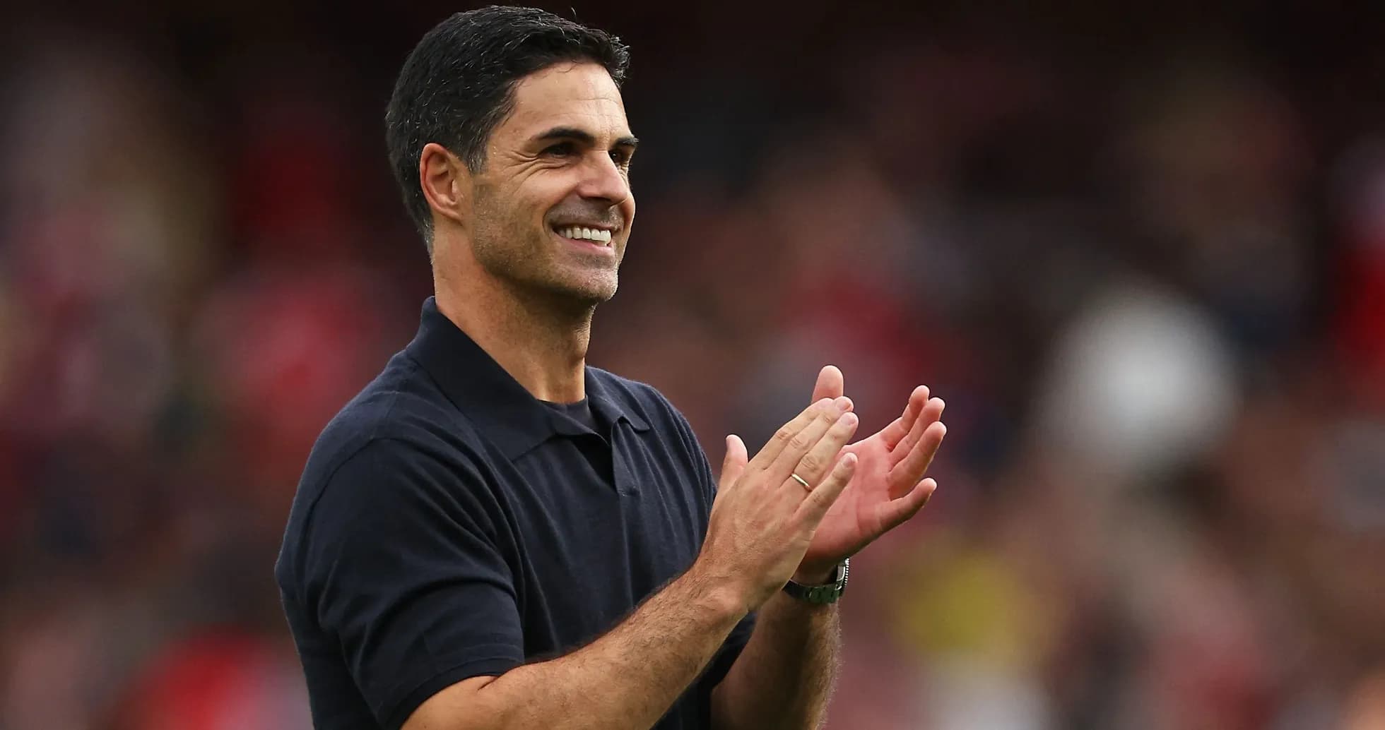 Manager applauding during a match on the sidelines