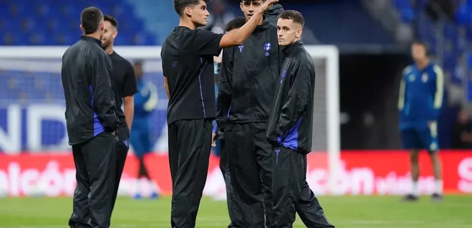 Players discussing on the pitch during warm-up