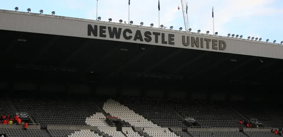 Newcastle United stadium with empty seats and signage