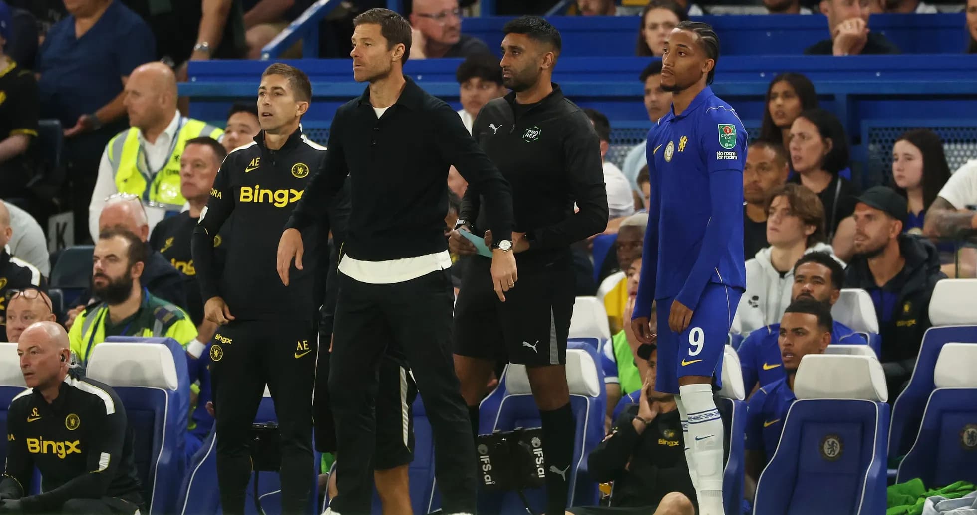 Coaches and players on the bench during match