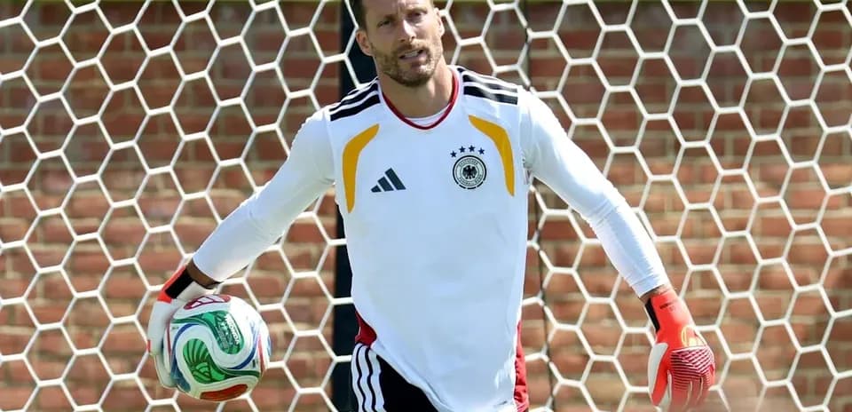 Goalkeeper training with ball near goal net