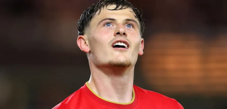 Player in red jersey looking upwards after match