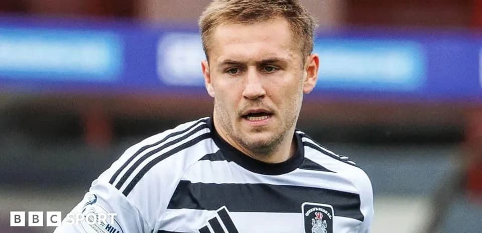Player in striped football kit during match
