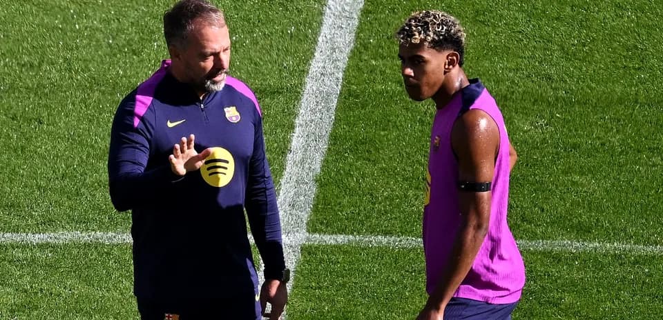 Coach speaking with player during training session
