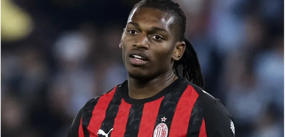 AC Milan player in black and red jersey during match