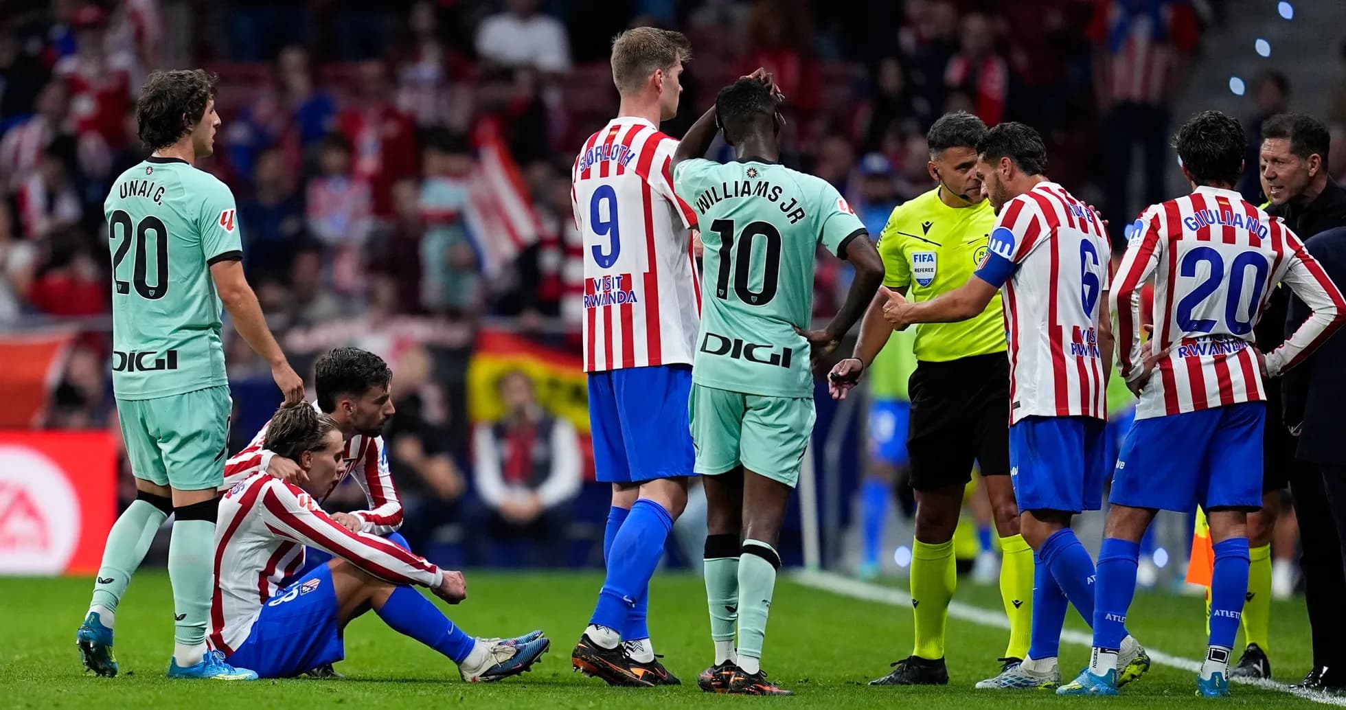 Atletico Madrid players discussing with referee