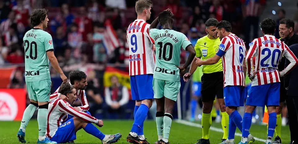 Atletico Madrid players discussing with referee