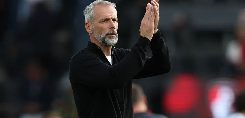Coach applauding fans during a match