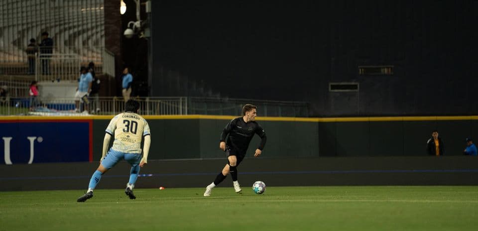 Player dribbling the ball in USL match