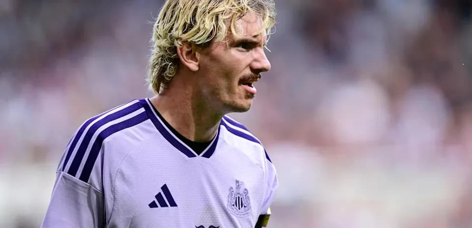 Newcastle player in purple kit on the field