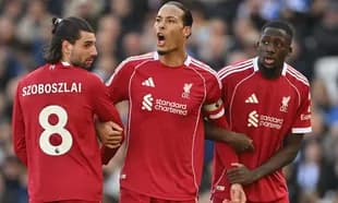 Liverpool players discussing during a match