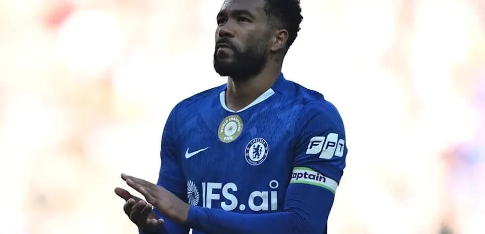 Player in blue jersey clapping during match