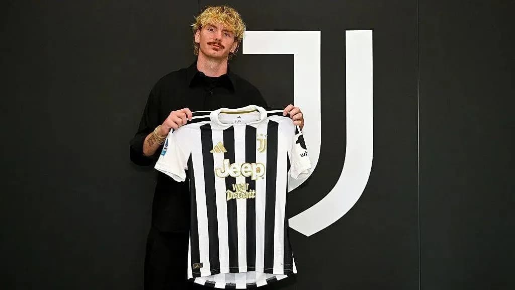 Player holding Juventus jersey at presentation event