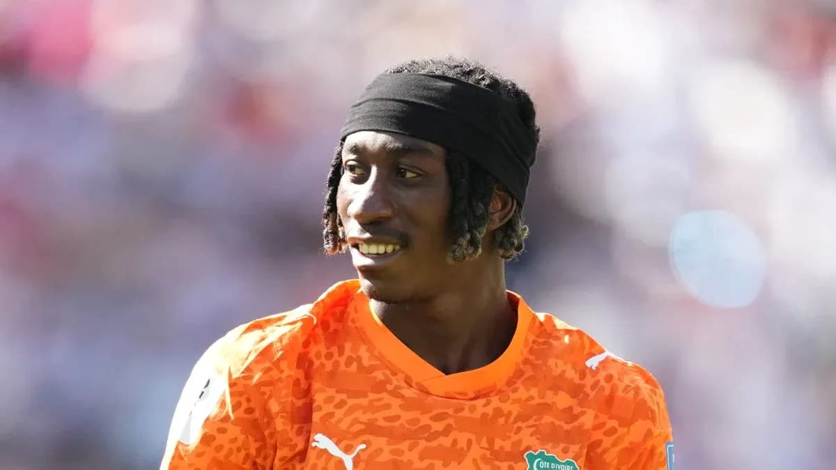 Player in orange jersey during match warm-up