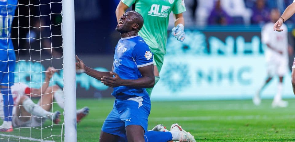 Player on knees near goalpost after missed opportunity