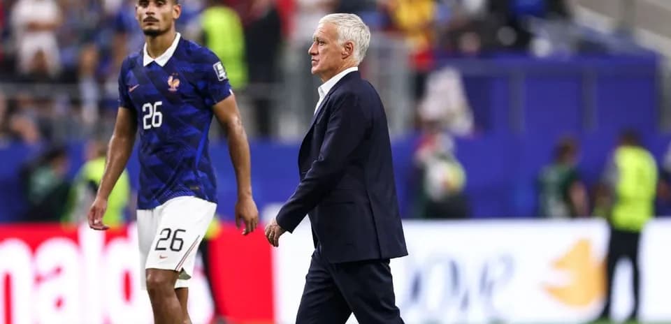 France coach Didier Deschamps walking past player