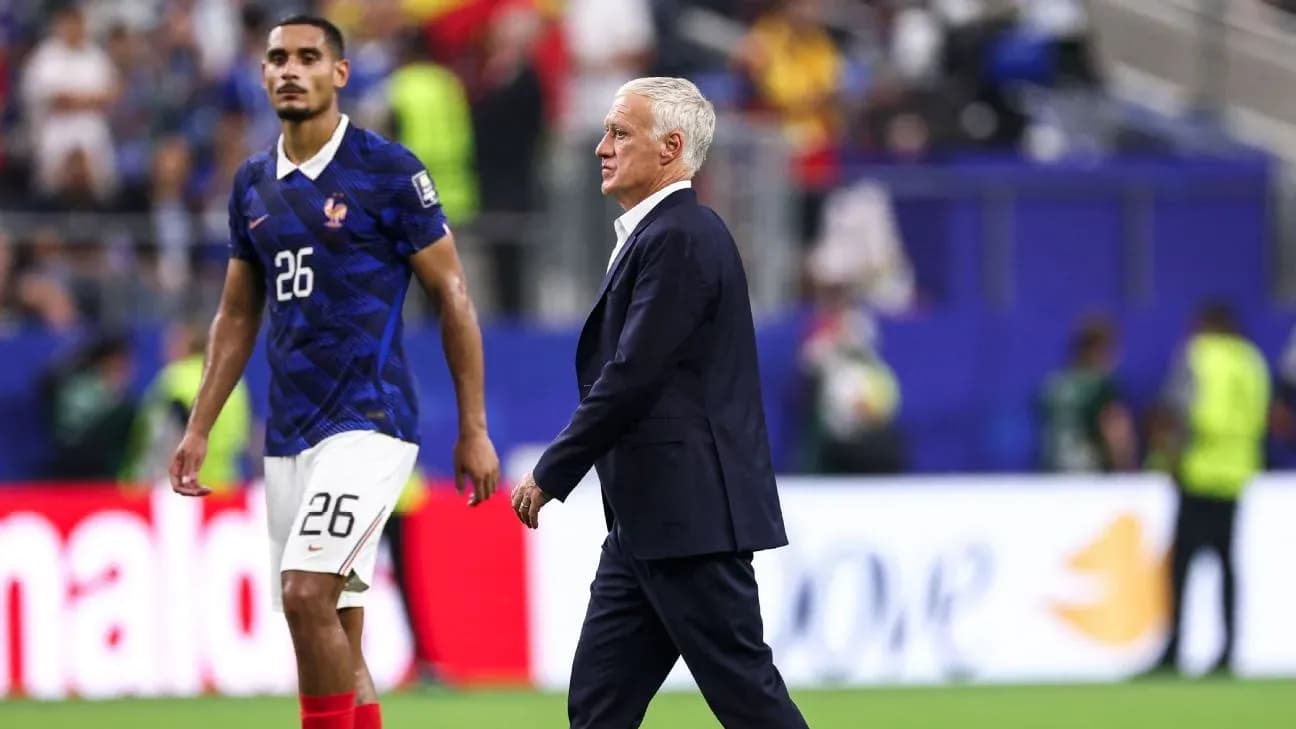 France coach Didier Deschamps walking past player