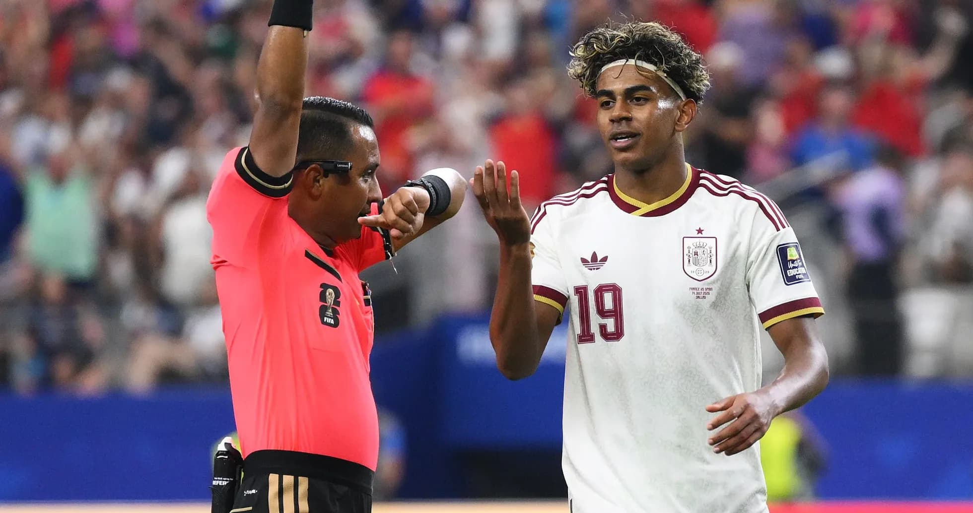 Referee signaling a decision to player during match